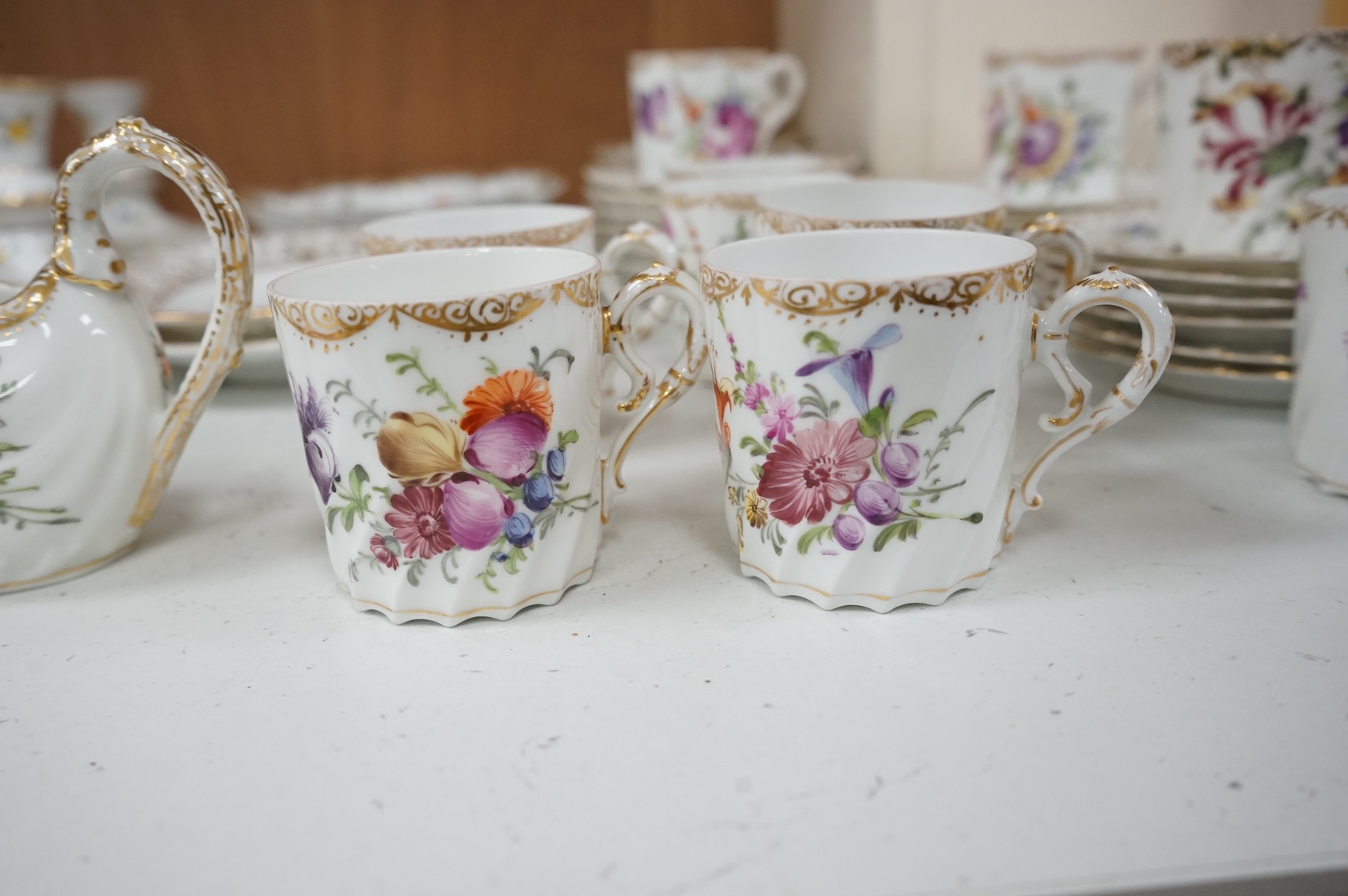 A Dresden porcelain part tea set together with reticulated side plates, largest 26cm in diameter